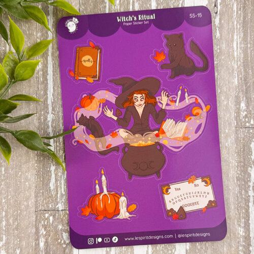 The Witch's Ritual ~ Paper Sticker Sheet features a witch on a purple background with magical items—black cat, cauldron, spellbook, pumpkins, candles, and potion bottles—framed by leafy plants on the left.