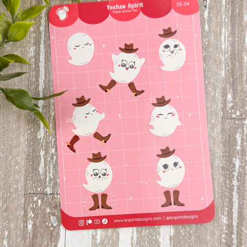 A sheet of cute ghost stickers featuring ghosts wearing brown cowboy hats and boots, each with different playful and happy expressions, on a pink grid background. Some green leaves are partially visible in the corner.