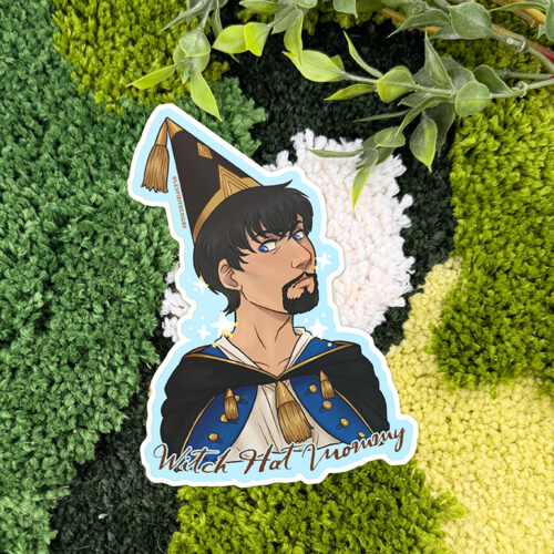 A 3" matte vinyl sticker called "Uppies Hamster" is placed on a green and white textured surface with leafy plant stems above.