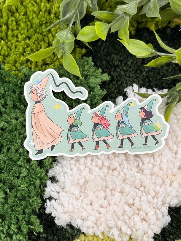 The Uppies Hamster ~ 3" Matte Vinyl Sticker features a white-haired wizard guiding four children in green outfits and hats, all walking in a line amid lush greenery and textured green-and-white fabric.