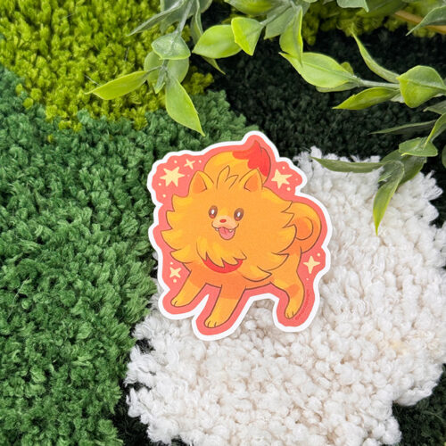 An Uppies Kitty ~ 3" Matte Vinyl Sticker featuring a cute, orange, fluffy cat with a bushy tail rests on a textured, multicolored rug beneath green leafy plant stems.