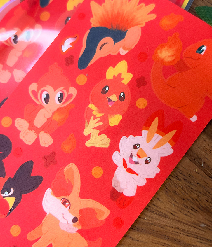 The Fire Starters ~ Deco Sticker Sheet features bright, colorful stickers of cute, cartoon-style fire-type Pokémon like Charmander, Torchic, Scorbunny, Chimchar, and Fennekin on a vibrant red background.