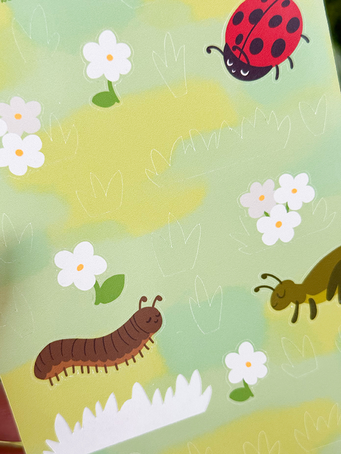 Cartoon of a ladybug, centipede, and millipede on grass with white flowers and plants on a light green background.